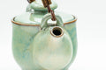 Japanese Tea Set - Green Glazed Dobin Do-ake Teapot with Katakuchi Water Cooler and 2 Yunomi Teacups - three-quarter view of the dobin teapot