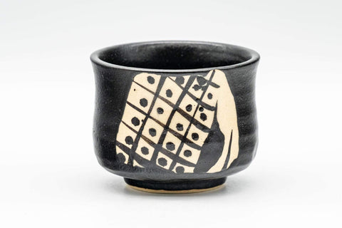 Tezumi — Japanese Teacup - Matte Black Glazed Geometric Motif Yunomi - 70ml — tipped to show the interior